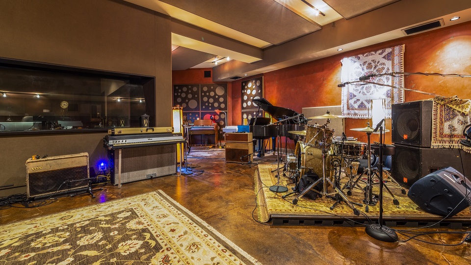 Image of a music studio with instruments scattered around